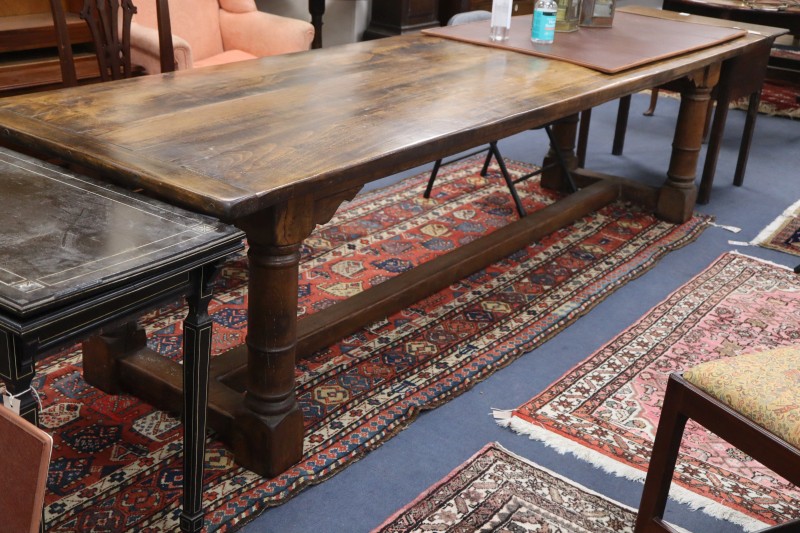 An oak and beech 18th century style refectory style dining table, L.296cm, W.86cm, H.75cm